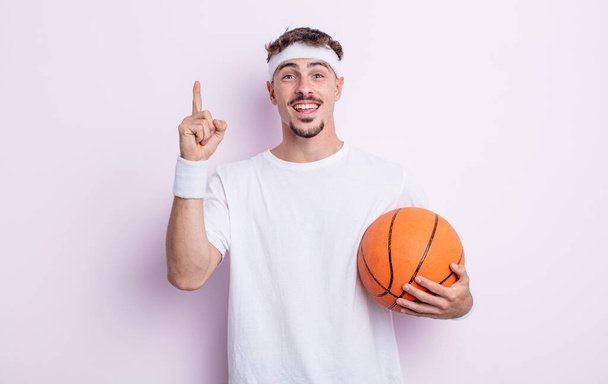 young handsome man feeling like a happy and excited genius after realizing an idea. basketball concept - Fotografie, Obrázek
