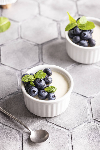 Sweet dessert vanilla panna cotta with blueberries - Fotó, kép