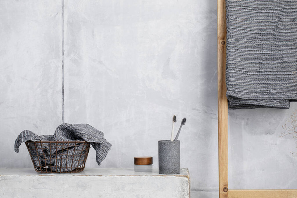 Organic waffle linen towels, bamboo toothbrushes, bathroom zero waste accessories in grey shades in contemporary bathroom interior. Daily body care, spa and wellness zero waste bathroom concept  - Photo, image