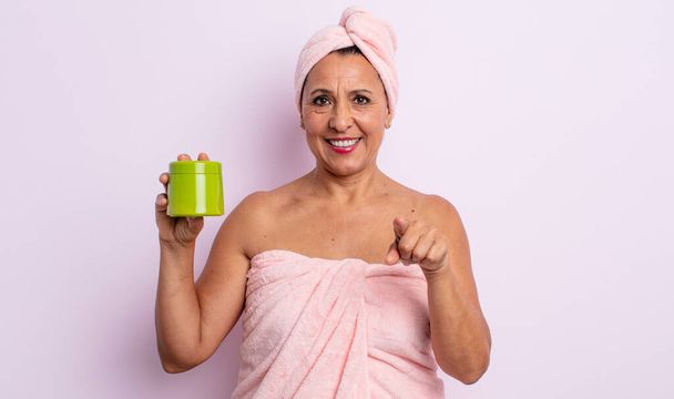 pretty middle age woman pointing at camera choosing you. shower and hair product concept - Fotografie, Obrázek