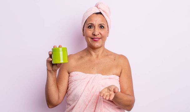 pretty middle age woman smiling happily with friendly and  offering and showing a concept. shower and hair product concept - 写真・画像