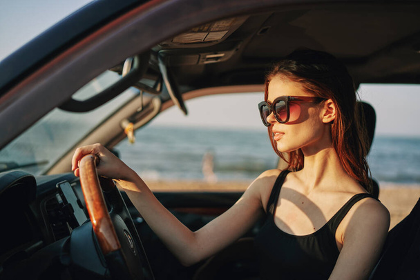 cheerful woman in sunglasses driving a car trip travel - Foto, Imagem