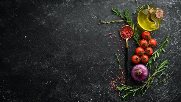 Black stone cooking background. Spices and vegetables. Top view. Free space for your text. - Foto, Imagem