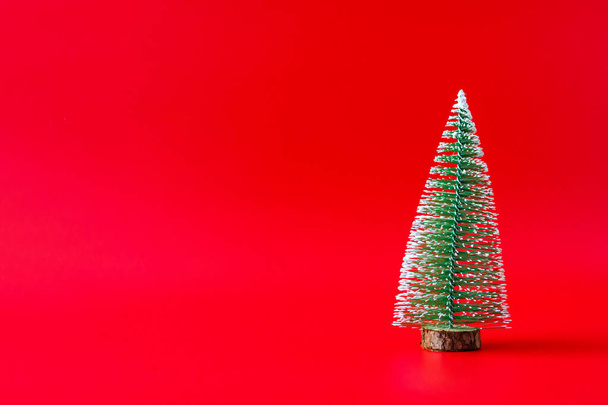 Christmas tree on red background new year  holiday celebration concept - Foto, Imagen