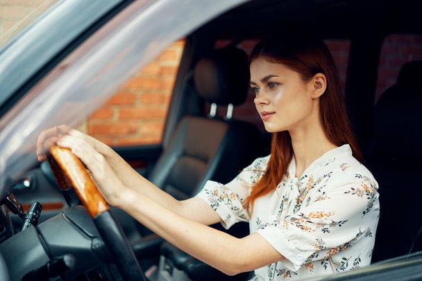 cute red-haired woman driving a car lifestyle trip - Photo, Image