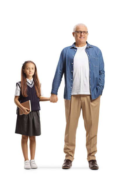 Full length portrait of a father and daughter holding hands isolated on white background - Zdjęcie, obraz