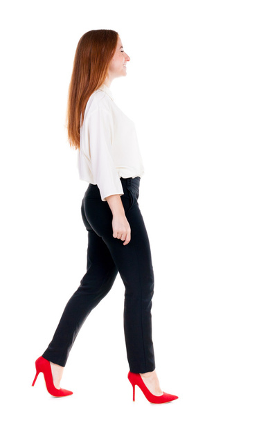 Walking redhead business woman. - Foto, afbeelding