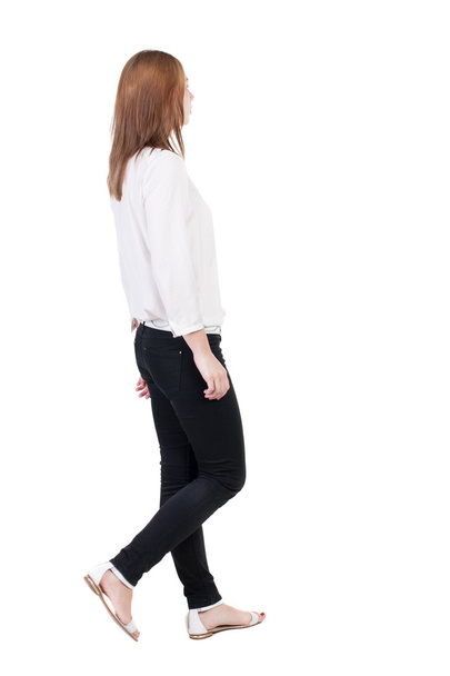 Walking woman in jeans Back view - Foto, Imagen
