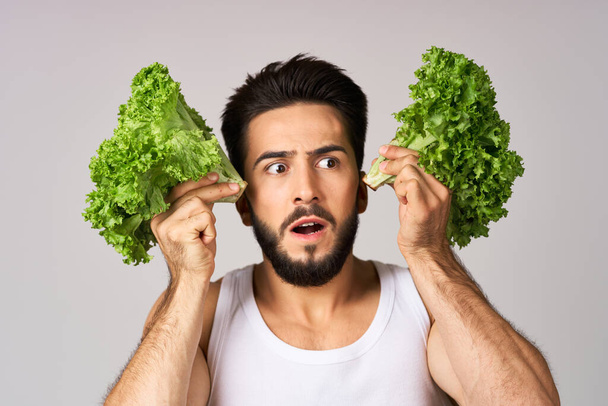 Cheerful man lettuce leaves healthy food posing - Photo, image