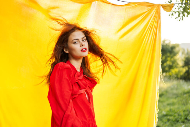 pretty woman in red dress outdoors nature yellow cloth - Photo, Image