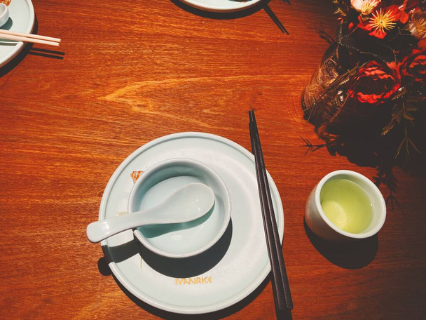 top view of japanese tea and chopsticks on wooden table - 写真・画像