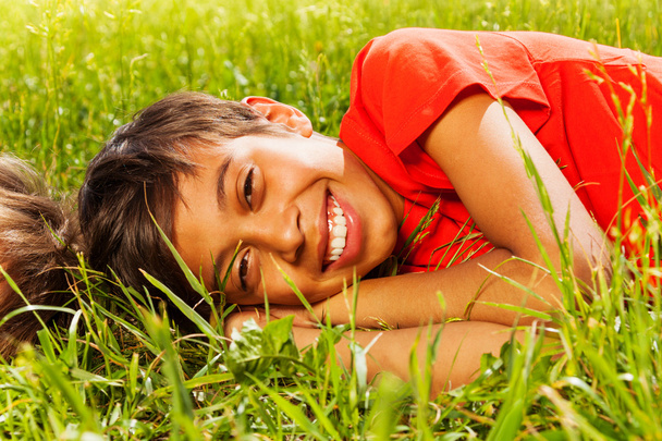 Happy smiling boy laying on grass - Fotoğraf, Görsel