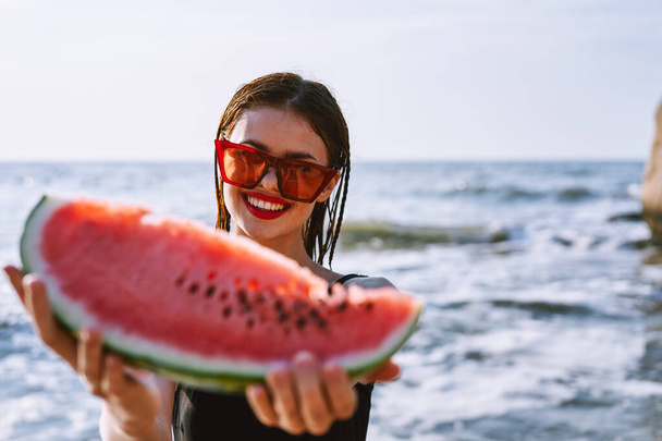 cheerful pretty woman in black swimsuit watermelon fashion travel - Фото, зображення