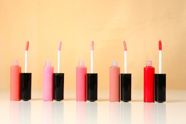 Beautiful lip glosses on color background - Photo, image