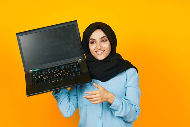 arab woman with laptop in hands technology emotions studio lifestyle - Фото, зображення