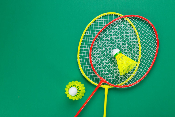 Two shuttlecock and badminton racket. on a green background. Concept summer relaxation. - Foto, imagen