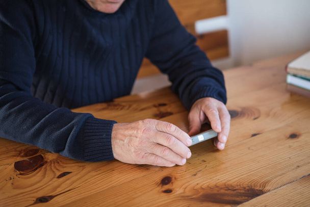 Senior businessman using mobile phone. Focus on hand.  Happy elderly senior people society lifestyle technology concept. - Valokuva, kuva