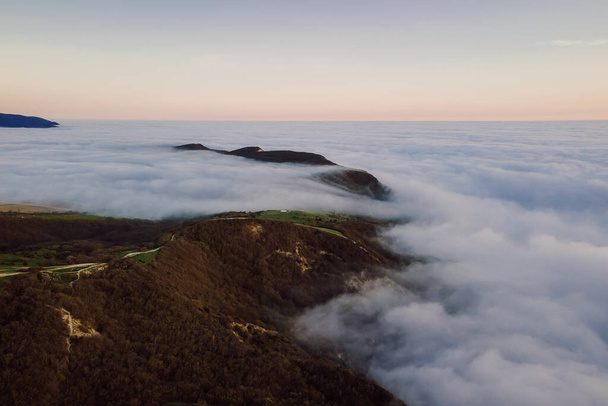 Aerial view with creeping fog and mountains. Foggy landscape - Fotoğraf, Görsel