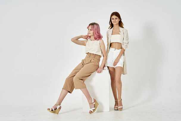 two models posing fashion friendship light background - Фото, зображення