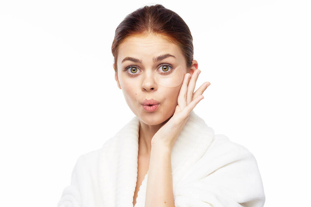 pretty woman in white robe face skin care collagen - Foto, immagini