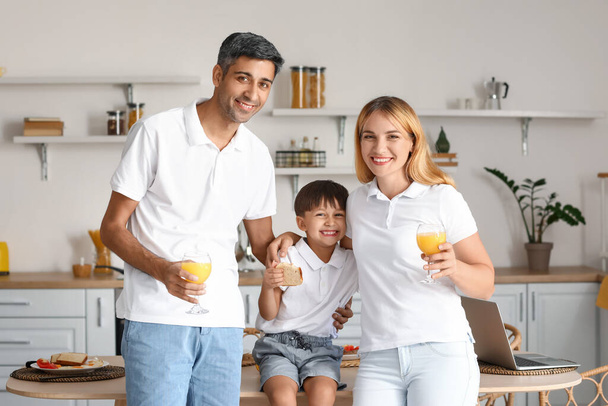 Szczęśliwi rodzice ze swoim synkiem jedzącym śniadanie w kuchni - Zdjęcie, obraz