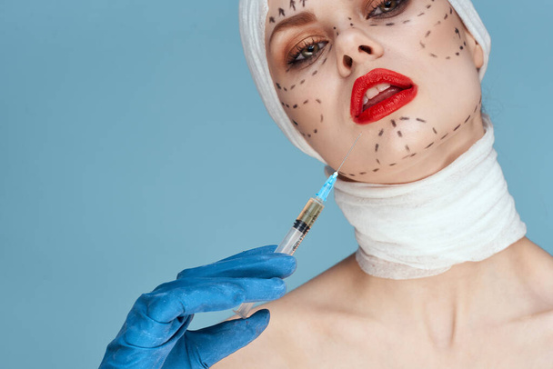 female patient in blue gloves syringe in hands contour on the face lifting close-up - Fotoğraf, Görsel