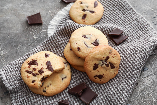 Delicious homemade cookies with chocolate chips on grey background - Φωτογραφία, εικόνα