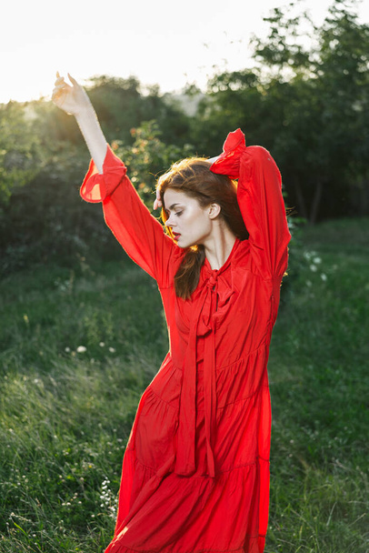 attractive woman in red dress posing in nature green grass - Φωτογραφία, εικόνα