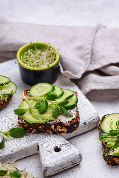 Toasts with avocado and microgreen - 写真・画像