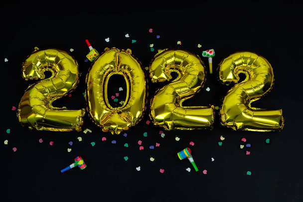 Gold numbers 2022 on black background. Copy space. Happy New Year. - Photo, Image
