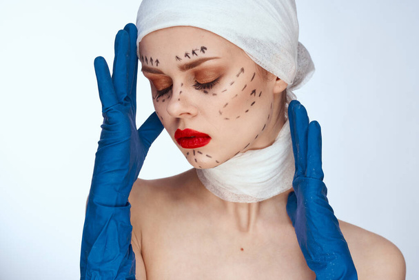 beautiful woman in blue gloves syringe in hands contour on the face lifting close-up - Fotó, kép