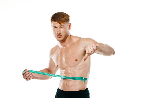 athletic man with measuring tape muscle workout - Fotoğraf, Görsel
