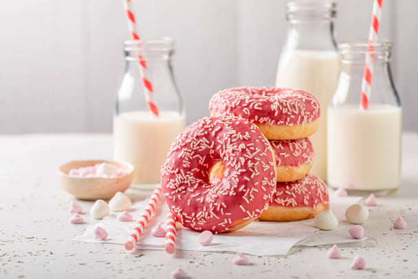 Delicious pink donuts for Fat Thursday. Best tastes with milk. Donates best taste with milk. - Fotó, kép