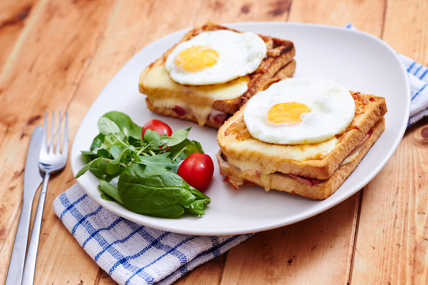 Croque madame with salad on wooden table - Photo, Image