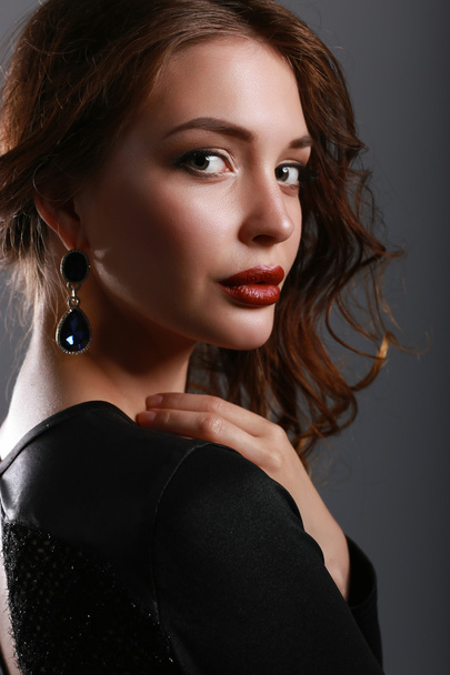 Portrait of beautiful brunette woman in black dress. - Photo, Image