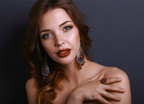Portrait of young beautiful brunette woman in ear-rings - Photo, image