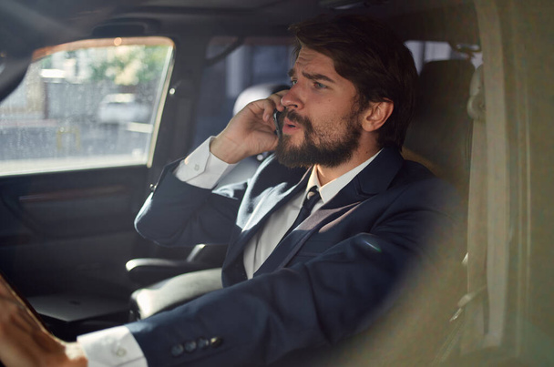 emotional man Driving a car trip luxury lifestyle communication by phone - Photo, Image