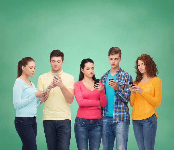 group of serious teenagers with smartphones - Zdjęcie, obraz