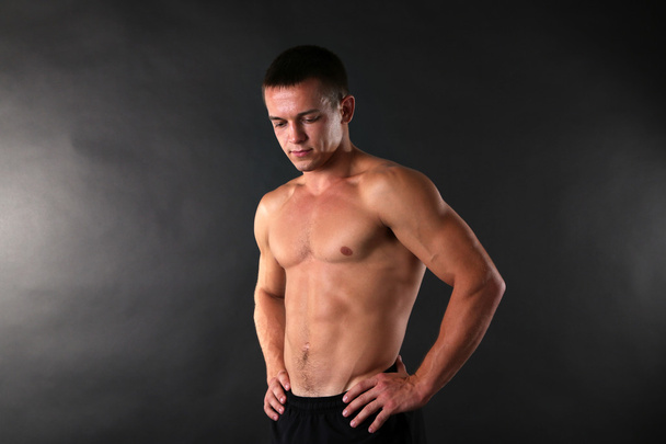 Handsome muscle young man on dark background - Foto, immagini