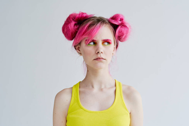 proportional woman with pink hair in a yellow tank top lifestyle - Fotografie, Obrázek