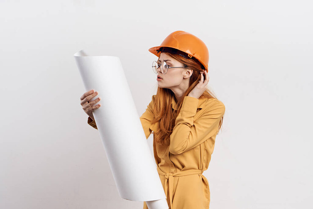 female engineer in orange hard hat blueprints architect - Φωτογραφία, εικόνα