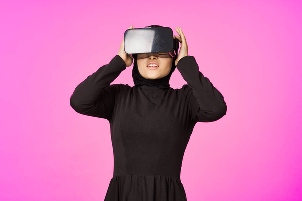 woman in black hijab glasses virtual reality technology movie watching - Фото, изображение