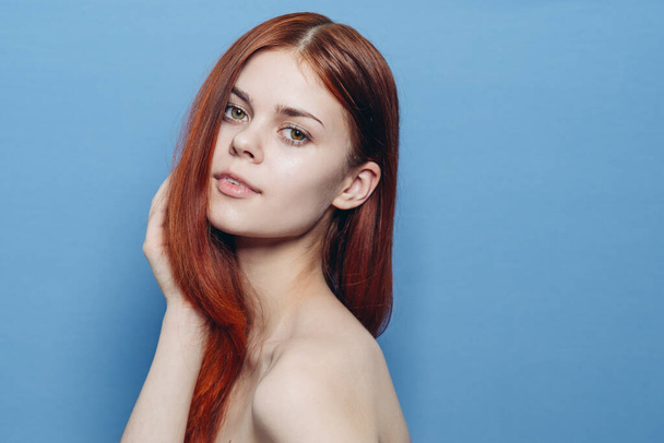 woman with bare shoulders red hair Glamor blue background - Zdjęcie, obraz