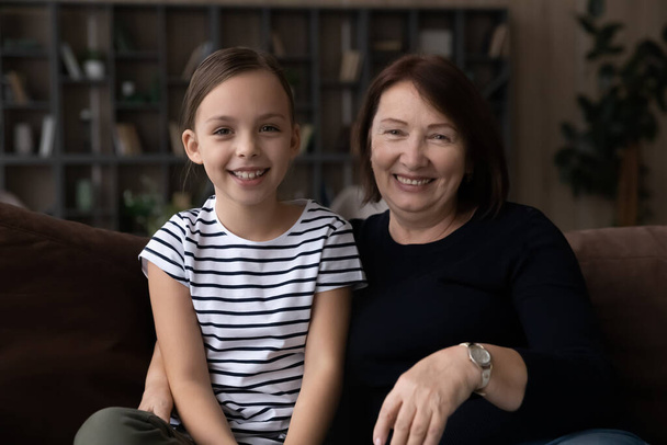 Head shot portrait smiling grandmother with granddaughter making video call - Photo, image