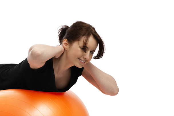 Young woman exercising with exercise ball - Foto, afbeelding