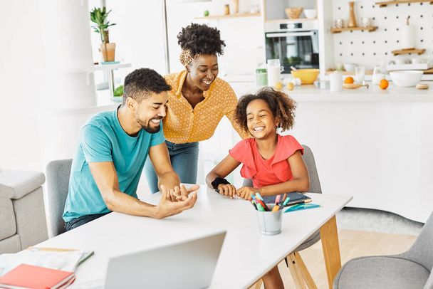 child family woman home happy man father mother lifestyle happiness daughter together parent love bonding cheerful fun table - 写真・画像