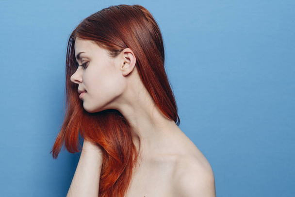 woman with bare shoulders red hair Glamor blue background - Fotó, kép