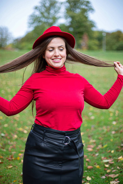 White young european woman in red autumn weather - Foto, Bild