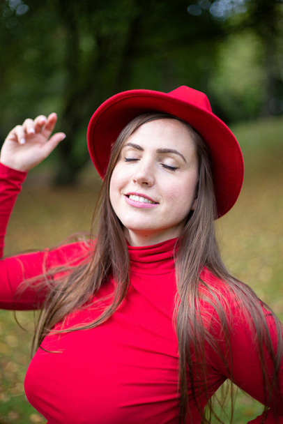Smiling white young european woman in red portrait - Фото, изображение