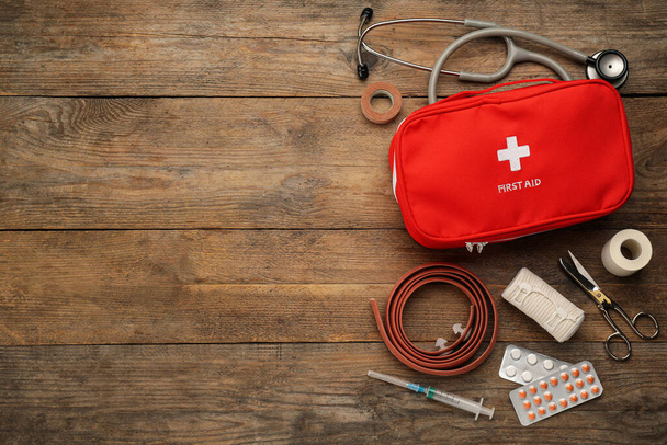 First aid kit on wooden table, flat lay. Space for text - Valokuva, kuva
